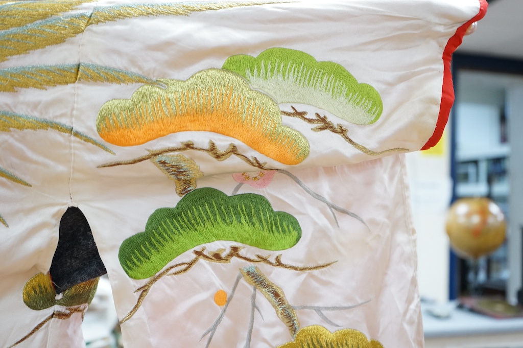 A late 20th century polychrome silk and metallic embroidered Japanese kimono, 133cm long. Condition - the silk is stained in places, which may be able to be cleaned.